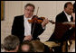 Violinist Itzhak Perlman plays during the entertainment portion of the White House State Dinner in honor on Her Majesty Queen Elizabeth II, Monday evening, May 7, 2007, in the East Room at the White House. White House photo by Shealah Craighead