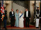 President George W. Bush and Mrs. Laura Bush escort Her Majesty Queen Elizabeth II and His Royal Highness The Prince Philip, Duke of Edinburgh, from the Grand Staircase of the White House Monday, May 7, 2007, prior to attending the State Dinner in the Queen's honor. White House photo by Lynden Steele