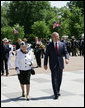 President George W. Bush escorts Her Majesty Queen Elizabeth II of Great Britain on a walk from the White House to Blair House Monday, May 7, 2007, where Queen Elizabeth II and His Royal Highness the Prince Philip, Duke of Edinburgh, are staying during their visit to Washington, D.C. White House photo by Eric Draper