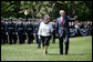 President George W. Bush waves to guests as he escorts Her Majesty Queen Elizabeth II of Great Britain during a review of the troops Monday, May 7, 2007, at the state arrival ceremony on the South Lawn of the White House. White House photo by David Bohrer