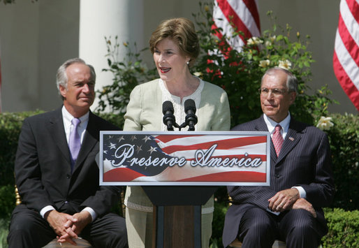 Mrs. Laura Bush is joined by U.S. Secretary of the Interior Dirk Kempthrone, left, and Jon Nau III, chairman of the Advisory Council on Historic Preservation, as she addreses guests in the White House Rose Garden, Wednesday, May 9, 2007, during the Preserve America President Awards ceremony. White House photo by Joyce Boghosian