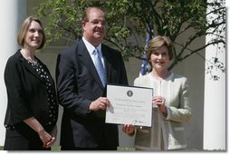 Mrs. Laura Bush poses with Mayor Wayne McCullen of Natchitoches, La., center, and Nancy Morgan, Cane River National Hertiage Area commission executive director, as she presents them with a 2007 Preserve America Presidential Award in the Rose Garden at the White House Wednesday, May 9, 2007, honored for their implementation of a comprehensive hertiage tourism plan for their region.  White House photo by Joyce Boghosian