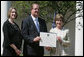 Mrs. Laura Bush poses with Mayor Wayne McCullen of Natchitoches, La., center, and Nancy Morgan, Cane River National Hertiage Area commission executive director, as she presents them with a 2007 Preserve America Presidential Award in the Rose Garden at the White House Wednesday, May 9, 2007, honored for their implementation of a comprehensive hertiage tourism plan for their region. White House photo by Joyce Boghosian