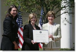 Mrs. Laura Bush presents a plaque to Abbe Raven, center, president and CEO of A&E Television Networks, and Nancy Dubuc, president of The History Channel, honoring them with a 2007 Preserve America Presidential Award in the Rose Garden at the White House Wednesday, May 9, 2007, honored for the establishment of the Save Our History grant program for historic preservation, and promotion of the historic hertiage of America.  White House photo by Joyce Boghosian