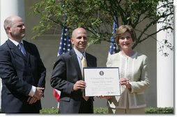Mrs. Laura Bush presents a plaque to Craig Heller, center, president of Loftworks and John Steffen, left, president of Pyramid Construction, honoring them with a 2007 Preserve America Presidential Award in the Rose Garden at the White House Wednesday, May 9, 2007. The Steffen and Heller companies were honored for their work in preserving and revitalizing the historic downtown of St. Louis, Mo.  White House photo by Joyce N. Boghosian