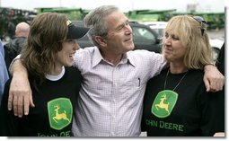 President George W. Bush offers some encouragement to two employees of the John Deere dealership in Greensburg, Kansas Wednesday, May 9, 2007, during a tour of the small, Midwest community that lost nearly 95 percent of its homes and businesses in the wake of a deadly tornado.  White House photo by Eric Draper