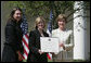 Mrs. Laura Bush presents a plaque to Abbe Raven, center, president and CEO of A&E Television Networks, and Nancy Dubuc, president of The History Channel, honoring them with a 2007 Preserve America Presidential Award in the Rose Garden at the White House Wednesday, May 9, 2007, honored for the establishment of the Save Our History grant program for historic preservation, and promotion of the historic hertiage of America. White House photo by Joyce Boghosian