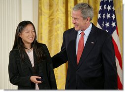 President George W. Bush congratulates Anna DeSanctis of Houston, Texas, after presenting her with the President’s Volunteer Service Award Thursday, May 10, 2007, in the East Room of the White House, celebrating Asian Pacific American Heritage Month.  White House photo by Eric Draper
