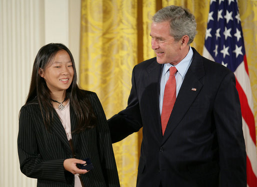 President George W. Bush congratulates Anna DeSanctis of Houston, Texas, after presenting her with the President’s Volunteer Service Award Thursday, May 10, 2007, in the East Room of the White House, celebrating Asian Pacific American Heritage Month. White House photo by Eric Draper