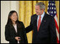President George W. Bush congratulates Anna DeSanctis of Houston, Texas, after presenting her with the President’s Volunteer Service Award Thursday, May 10, 2007, in the East Room of the White House, celebrating Asian Pacific American Heritage Month. White House photo by Eric Draper