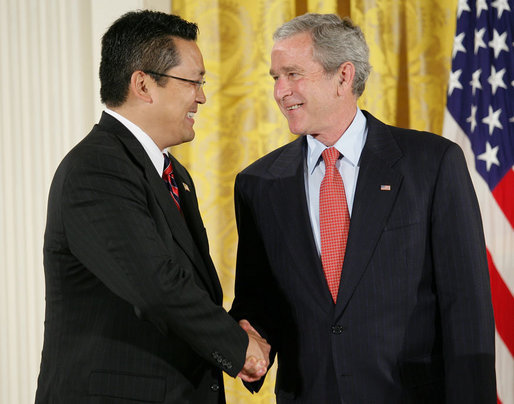 President George W. Bush shakes hands with Kay Hiramine of Colorado Springs, Colo., as he presents Hiramine with the President’s Volunteer Service Award Thursday, May 10, 2007, in the East Room of the White House, in celebration of Asian Pacific American Heritage Month. White House photo by Eric Draper