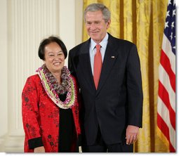 President George W. Bush welcomes Linda Uehara of Mililani, Hawaii, to the stage in the East Room of the White House, to receive the President’s Volunteer Service Award Thursday, May 10, 2007, in celebration of Asian Pacific American Heritage Month.  White House photo by Eric Draper