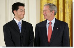 President George W. Bush welcomes Jonathan Wu of Fremont, Calif., to the stage in the East Room of the White House, where he received the President’s Volunteer Service Award Thursday, May 10, 2007, in celebration of Asian Pacific American Heritage Month.  White House photo by Eric Draper