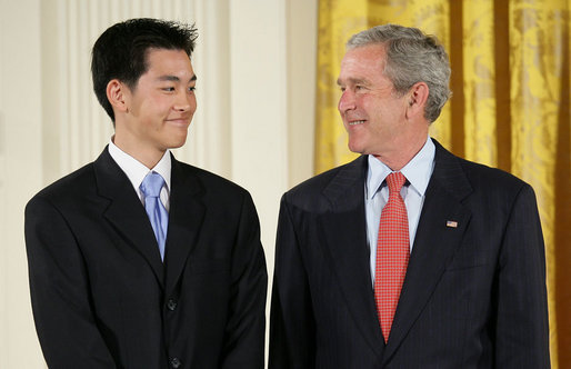 President George W. Bush welcomes Jonathan Wu of Fremont, Calif., to the stage in the East Room of the White House, where he received the President’s Volunteer Service Award Thursday, May 10, 2007, in celebration of Asian Pacific American Heritage Month. White House photo by Eric Draper