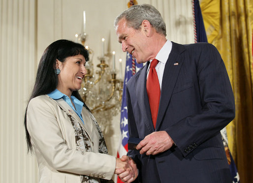 President George W. Bush shakes hands with military spouse Michele Langford of Alameda, Calif., a recipient of the President’s Volunteer Service Award Friday, May 11, 2007, presented in the East Room of the White House during a celebration of Military Spouse Day. White House photo by Eric Draper
