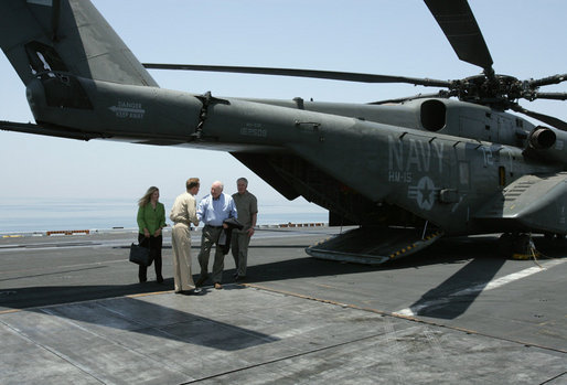 USS John C. Stennis Strike Group Commander Rear Admiral Kevin Quinn greets Vice President Dick Cheney and his daughter Liz Cheney, left, upon their arrival, Friday, May 11, 2007, to the aircraft carrier John C. Stennis in the Persian Gulf. White House photo by David Bohrer