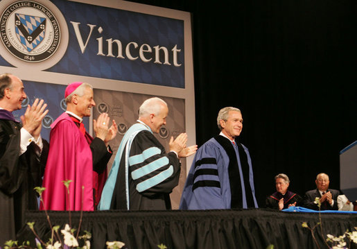 President George W. Bush is applauded by Saint Vincent College President Jim Towey, center, and Washington Archbishop Donald Wuerl as he is introduced on stage Friday, May 11, 2007, prior to delivering the commencement address at Saint Vincent College in Latrobe, Pa. White House photo by Joyce Boghosian