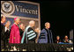 President George W. Bush is applauded by Saint Vincent College President Jim Towey, center, and Washington Archbishop Donald Wuerl as he is introduced on stage Friday, May 11, 2007, prior to delivering the commencement address at Saint Vincent College in Latrobe, Pa. White House photo by Joyce Boghosian
