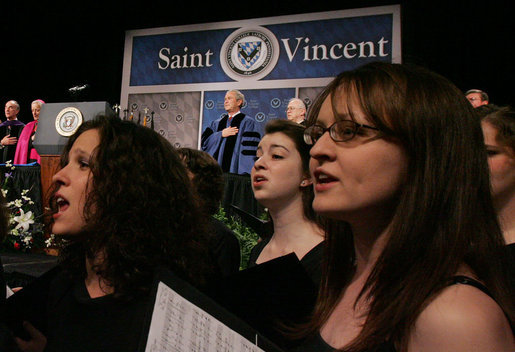 President George W. Bush stands for the singing of the national anthem Friday, May 11, 2007, prior to delivering the commencement address at Saint Vincent College in Latrobe, Pa. White House photo by Joyce Boghosian