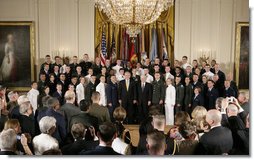 President George W. Bush and U.S. Secretary of Defense Robert Gates pose for a group photo at the commissioning ceremony for Joint Reserve Officer Training Corps Thursday, May 17, 2007, in the East Room of the White House. White House photo by Joyce N. Boghosian