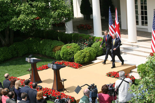 President George W. Bush and Prime Minister Tony Blair of the United Kingdom, walk to the podiums Thursday, May 17, 2007, to begin their joint press availability in the Rose Garden. The visit by Prime Minister Blair marks his last visit in that capacity following his announcement that he'll leave office in June. White House photo by Shealah Craighead