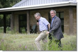 President George W. Bush and NATO Secretary-General Jaap de Hoop Scheffer walk the grounds of the Bush Ranch in Crawford, Texas Monday, May 21, 2007. During the two-day visit, the leaders discussed a variety of issues including Afghanistan and missile defense.  White House photo by Shealah Craighead