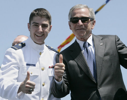 President George W. Bush, wearing the sunglasses of U.S. Coast Guard graduate Steven Matthew Volk, poses with Volk for a thumbs-up photo following the President’s address to the graduates Wednesday, May 23, 2007, at the U.S. Coast Guard Academy commencement in New London, Conn. White House photo by Joyce Boghosian