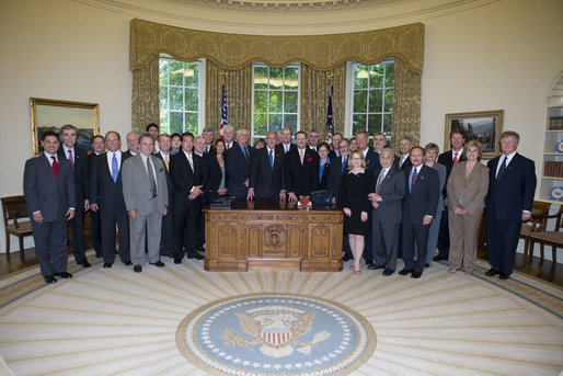 President George W. Bush stands with the recipients of the 2006 President's "E" award and "E" Star award for export achievement, May 24, 2007, in the Oval Office. The “E” Award is presented by the Department of Commerce to persons and organizations engaged in the marketing of products that make significant contributions to the expansion of the export trade of the United States. White House photo by Joyce Boghosian