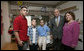 President George W. Bush stands with Cpl. Manuel Provencio of Tucson, after awarding him a Purple Heart Friday, May 25, 2007, during a visit to the National Naval Medical Center in Bethesda, Md., where the Marine is recovering from wounds received in Operation Iraqi Freedom. With them are Cpl. Provencio's mother, Manuela, and brothers, Carlos, in red, and Angel. White House photo by Joyce N. Boghosian