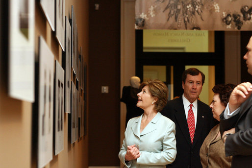 Joined by Dr. R Gerald Turner, President of Southern Methodist University, and Myra Walker, guest curator, Mrs. Laura Bush looks at magazine covers that feature Balenciaga's dresses during a tour of The Balenciaga exhibition at the Meadows Museum Saturday, May 26, 2007, in Dallas. White House photo by Shealah Craighead
