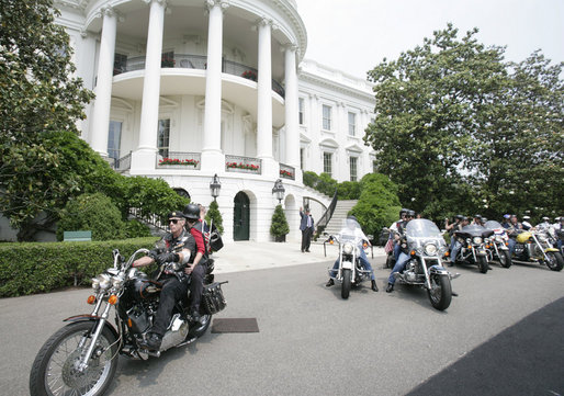 President George W. Bush bids farewell to members of the Rolling Thunder motorcycle organization, as they drive away from the South Portico of the White House following their visit Sunday, May 27, 2007. Rolling Thunder, founded by a group of Vietnam veterans in 1987, marks its 20th year of supporting U.S. troops overseas, at home and missing in action. White House photo by Chris Greenburg