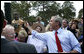 President George W. Bush reaches up to shake the hand of a youngster Tuesday, May 29, 2007, after delivering remarks on comprehensive immigration reform during a visit to the Federal Law Enforcement Training Center in Glynco, Ga.  White House photo by Eric Draper