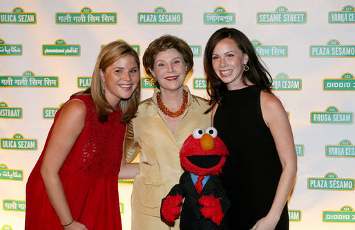 Mrs. Laura Bush is joined by her daughters Jenna Bush, left, and Barbara Bush, as they pose for a photo with Sesame Street character Elmo Wednesday evening, May 30, 2007, at the Sesame Workshop Fifth Annual Benefit Dinner in New York, where Mrs. Bush was honored for her commitment to literacy and education. White House photo by Shealah Craighead