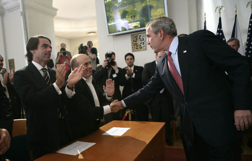 President George W. Bush reaches out to shake the hands of Jose Maria Aznar, left, former Prime Minister of Spain, and Natan Sharansky, Chairman of the Adelson Institute for Strategic Studies at the Shalem Center, after speaking Tuesday, June 5, 2007, to democracy advocates in Prague. White House photo by Eric Draper
