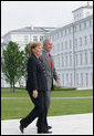 President George W. Bush walks with Germany's Chancellor Angela Merkel as the two leaders met for lunch Wednesday, June 6, 2007, at the Kempinski Grand Hotel in Heiligendamm, Germany. White House photo by Eric Draper
