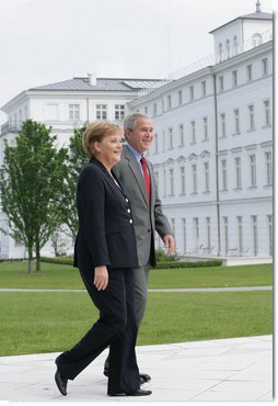 President George W. Bush walks with Germany's Chancellor Angela Merkel as the two leaders met for lunch Wednesday, June 6, 2007, at the Kempinski Grand Hotel in Heiligendamm, Germany.  White House photo by Eric Draper