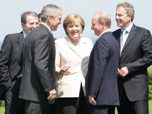President George W. Bush shares a moment with President Vladimir Putin of Russia, and Chancellor Angela Merkel of Germany, after a photo opportunity with Outreach Representatives at the G8 Summit in Heiligendamm, Germany. With them are Prime Minister Romano Prodi, left, of Italy, and Prime Minister Tony Blair of the United Kingdom. White House photo by Eric Draper