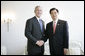 President George W. Bush shakes the hand of President Hu Jintao following their brief meeting Friday, June 8, 2007, prior to the working session of the G8 Summit in Heiligendamm, Germany. White House photo by Eric Draper