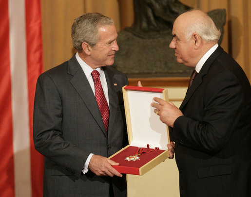 President George W. Bush accepts the Order of the National Flag Award from President Alfred Moisiu of Albania Sunday, June 10, 2007, during arrival ceremonies in Tirana welcoming the President and Mrs. Bush to the country. White House photo by Eric Draper