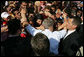 President George W. Bush is covered with the hands of Albanians has he's greeted with an outpouring of welcome Sunday, June 10, 2007, during a stop in Fushe Kruje. The stop marked the first time a sitting U.S. president has visited the country. White House photo by Eric Draper