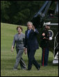 President George W. Bush and Mrs. Laura Bush return to the White House Monday afternoon, June 11, 2007, following their six-nation visit, including attending the G8 Summit. White House photo by Joyce Boghosian