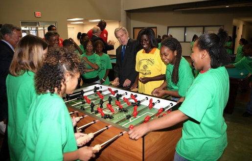 President George W. Bush joins a heated game of foosball Friday, June 15, 2007, during his visit to the Boys and Girls Club of South Central Kansas - 21st Street Club in Wichita. White House photo by Eric Draper