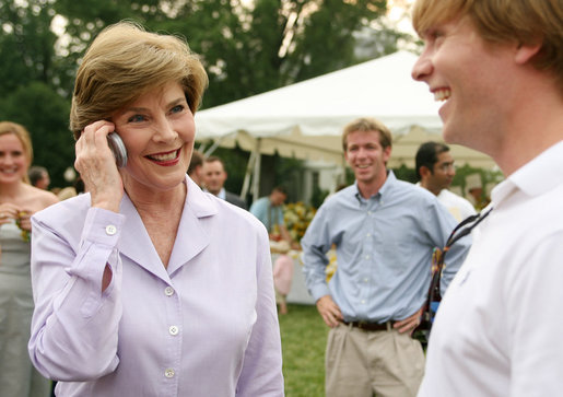 Mrs. Laura Bush surprises a caller on guest’s cell phone Tuesday evening, June 19, 2007, at the annual White House Congressional Picnic on the South Lawn. White House photo by Shealah Craighead