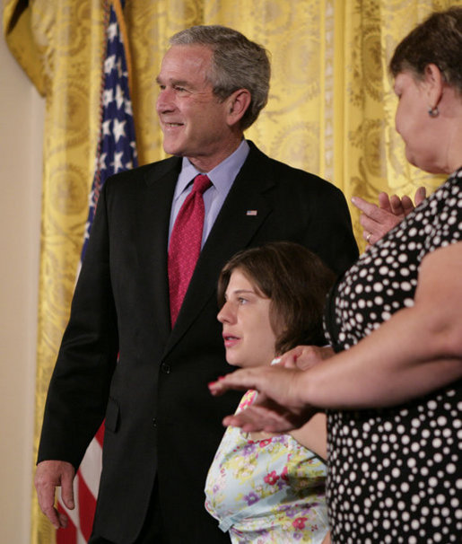 President George W. Bush embraces stem cell patient Kaitlyne McNamara following his address on the reasons he vetoed S.5, the “Stem Cell Research Enhancement Act of 2007,” in the East Room of the White House Wednesday, June 20, 2007. McNamara was born with spina bifida, a disease that damaged her bladder, her doctors isolated healthy stem cells in a piece of her own bladder and used them to grow her a new bladder. White House photo by Eric Draper