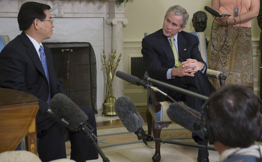 President George W. Bush listens to remarks by President Nguyen Minh Triet of Vietnam during his visit Friday, June 22, 2007, to the Oval Office. ".I would like to take this opportunity to send a message to American people," said President Triet, during the meeting. ".If both peoples both want peace, friendship and solidarity, then we should join hands and march toward the future." White House photo by Eric Draper