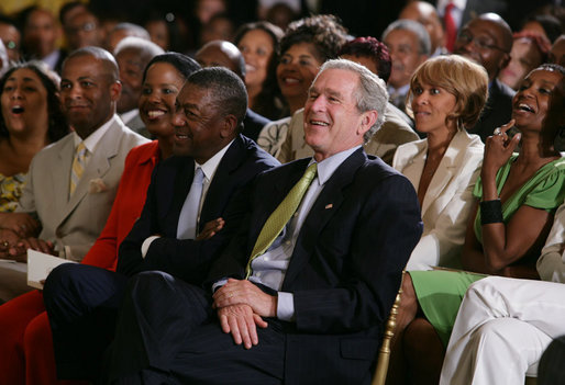 President George W. Bush, entrepreneur Bob Johnson, left, and invited guests respond to entertainers Friday, June 22, 2007 in the East Room of the White House, in celebration of Black Music Month. White House photo by Chris Greenberg