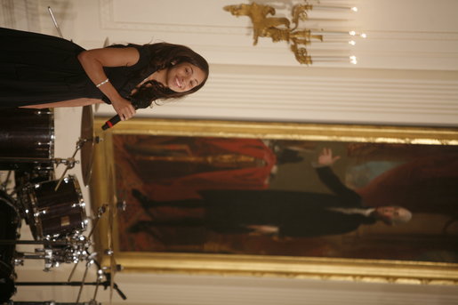 Singer Karina Pasian stands before a portrait of George Washington as she performs for President George W. Bush and guests Friday, June 22, 2007 in the East Room of the White House, in celebration of Black Music Month. White House photo by Debra Gulbas