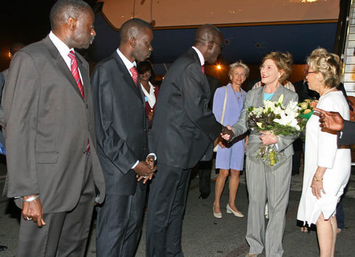Mrs. Laura Bush, arriving Monday evening, June 25, 2007 in Dakar, Senegal, is greeted by the First Lady of Senegal, Mrs. Viviane Wade, right, making introductions to Senegal Education Minister Dr. Moustapha Sourang , Dr. Issa Mbaye Samb, Minister of Health and Airport Director Mbaye Ndiaje, left. Mrs. Bush is traveling to Senegal, Mozambique, Mali and and Zambia to highlight efforts to combat Malaria and HIV/AIDS. White House photo by Shealah Craighead