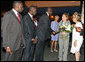 Mrs. Laura Bush, arriving Monday evening, June 25, 2007 in Dakar, Senegal, is greeted by the First Lady of Senegal, Mrs. Viviane Wade, right, making introductions to Senegal Education Minister Dr. Moustapha Sourang , Dr. Issa Mbaye Samb, Minister of Health and Airport Director Mbaye Ndiaje, left. Mrs. Bush is traveling to Senegal, Mozambique, Mali and and Zambia to highlight efforts to combat Malaria and HIV/AIDS. White House photo by Shealah Craighead