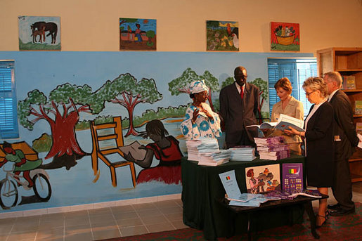 Mrs. Laura Bush and Senegal's First Lady Viviane Wade look through schoolbooks donated by Elizabeth City State University during a visit to Grand Medine Primary School Tuesday, June 26, 2007, in Dakar, Senegal. The books were donated through the Africa Education Initiative textbook program, which partners together African and American institutions. White House photo by Shealah Craighead